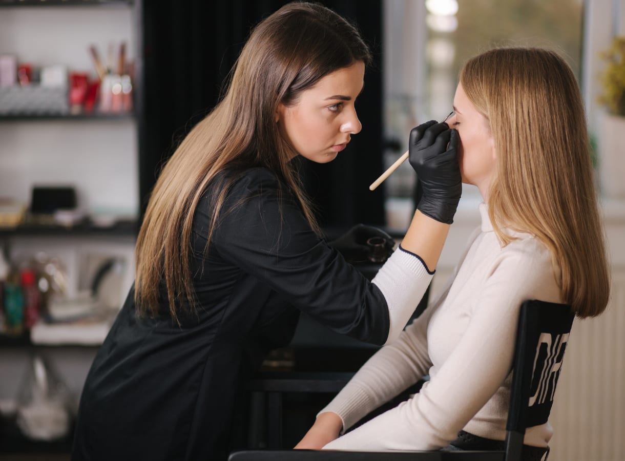 Beautician doing client's make up